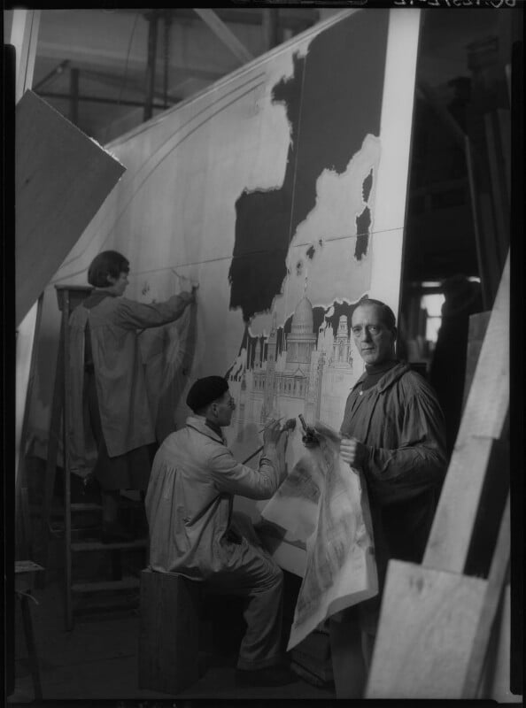 Macdonald-Gill-with-two-assistants-working-on-Decorative-Map-of-the-Atlantic-for-RMS-Queen-Mary